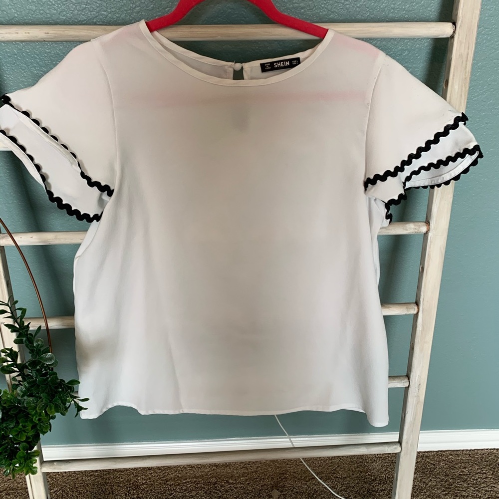 White blouse with black wavy layered sleeve detail